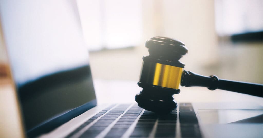 Stock photo of gavel on laptop. ADA accessibility of websites can lead to lawsuits if not addressed.