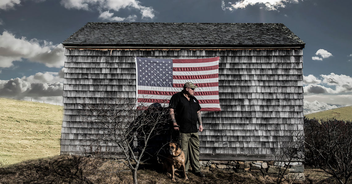 K9's for Warriors member with service dog in front of American Flag from Early Times Whisky campaign
