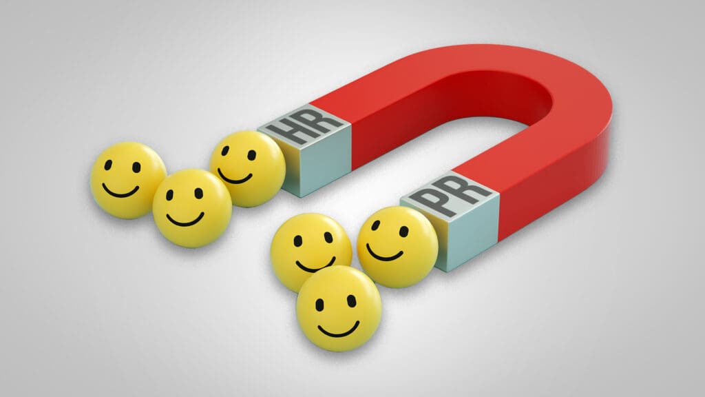 Magnet labeled PR and HR attracting smiley faces to represent brand awareness for recruitment