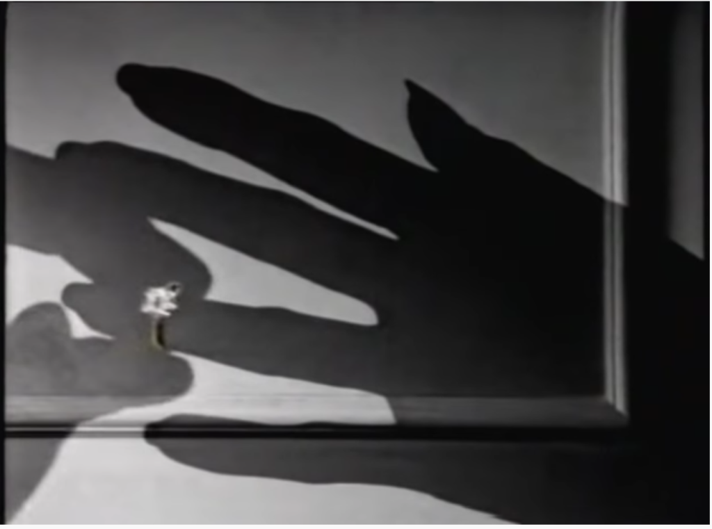 Shadow handing putting large diamond ring on female shadow hand, and example of black and white advertising.