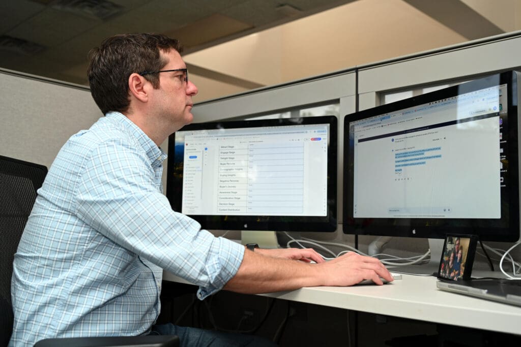 Market researcher looking at data on computer monitors at PriceWeber in Louisville, KY