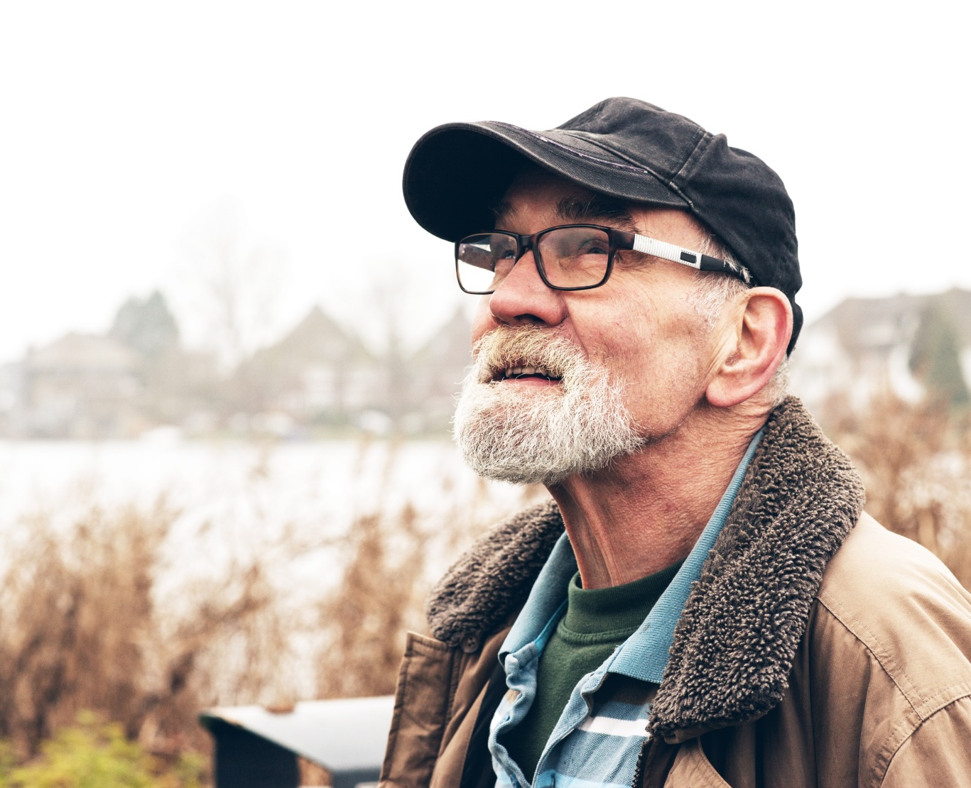 Specialists in Pain Care - An image of an elderly caucasian man wearing a hat in glasses standing outdoors