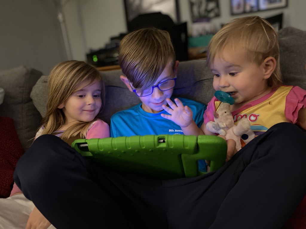 MK's three children watching tablet