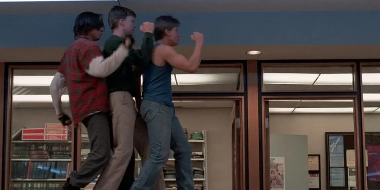 Three teenage boys dancing in a row, a scene from the movie "The Breakfast Club"