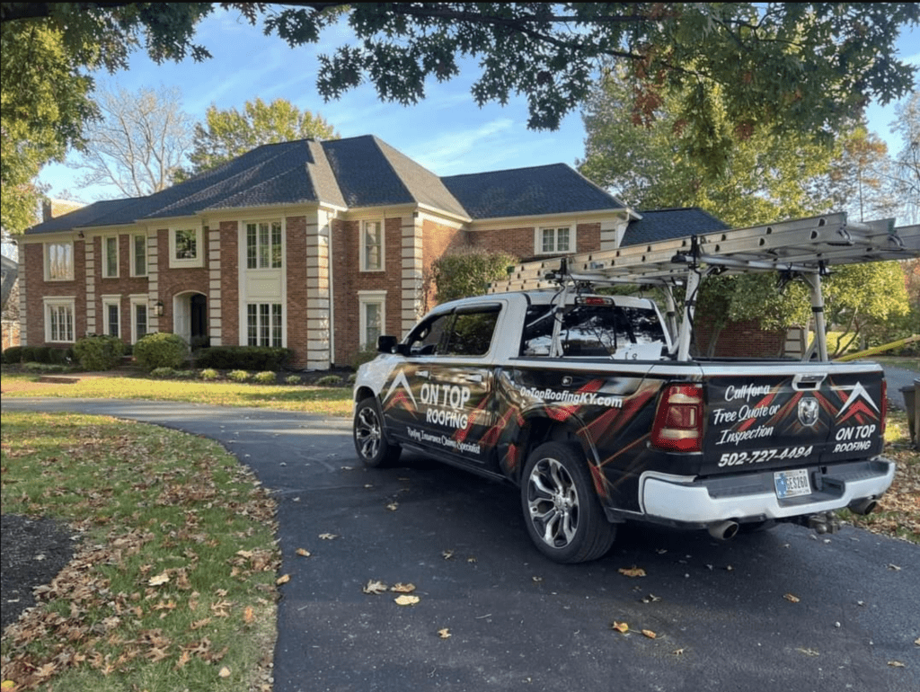 On Top Roofing Truck at large house to inspect roof