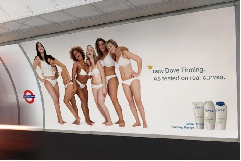 Subway ad for Dove Firming showing six diverse women in white underwear with the tagline: “As tested on real curves.” Dove products appear in the corner. An example of scaling marketing.