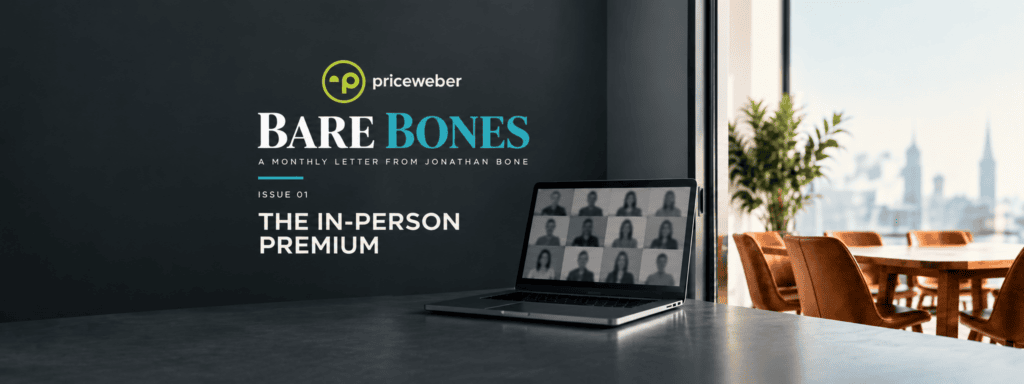 An image with a laptop open an people on a virtual meeting while a meeting table sits empty next to the laptop.