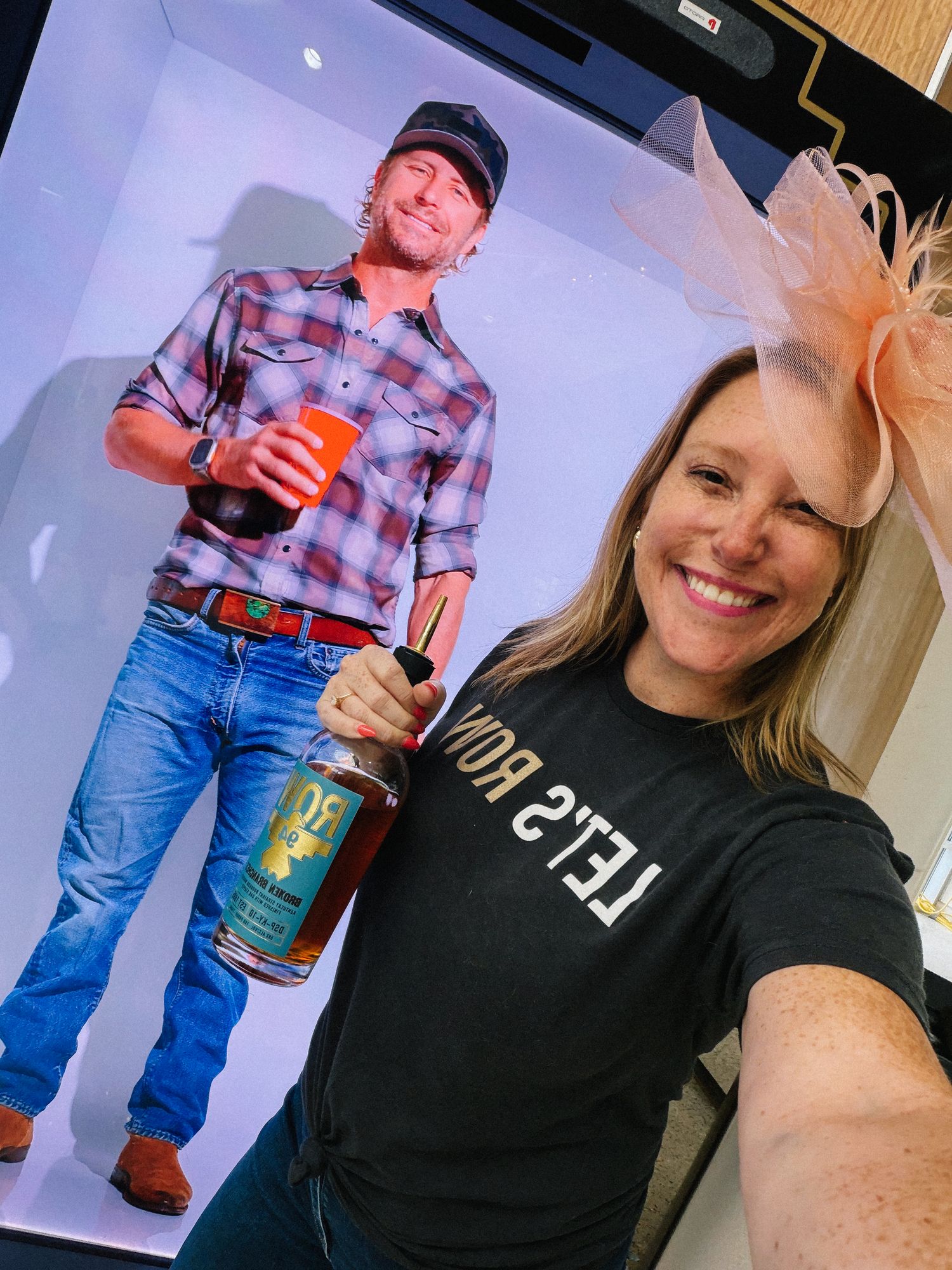ROW 94 team member posing beside the life-sized Dierks Bentley hologram