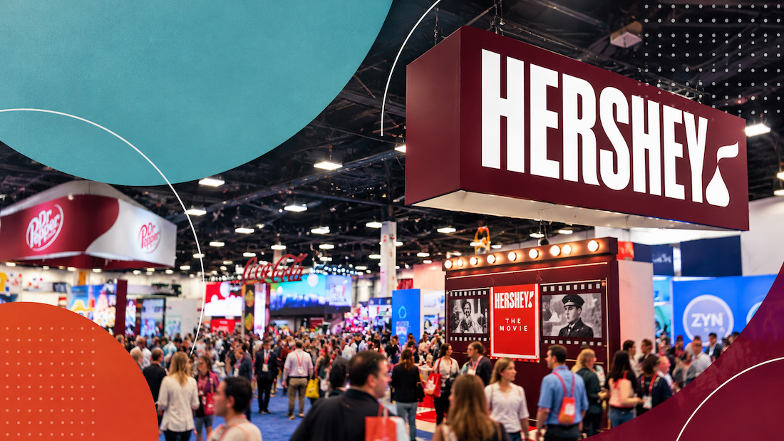 People walking trade show floor in front of Hersheys booth at NACS 2026.