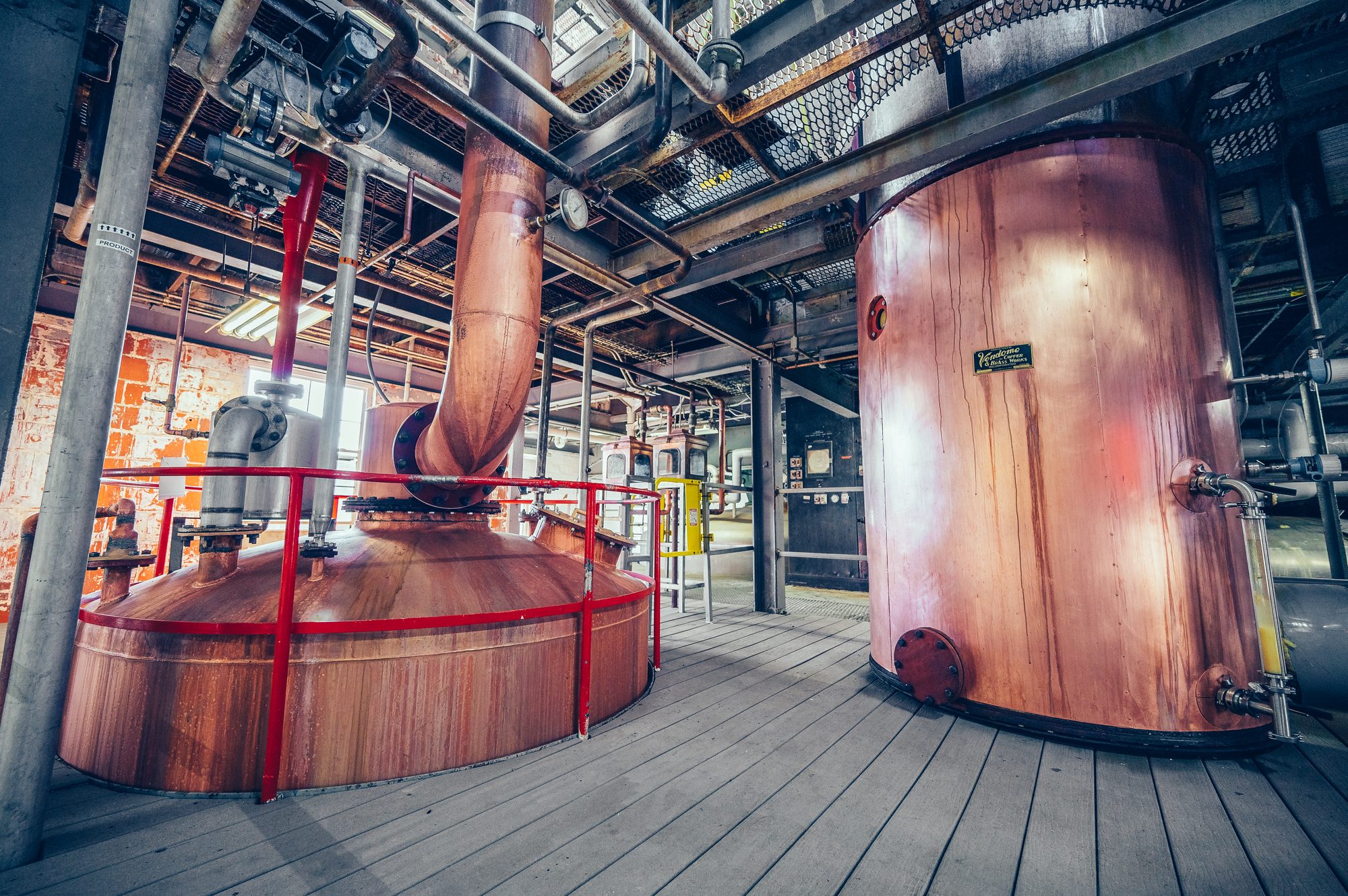 Copper stills and fermenters inside the distillery
