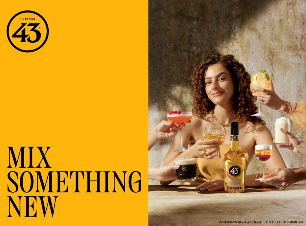 Licor 43 key visual with the headline "Mix Something New" beside a woman holding cocktails with a bottle of Licor 43